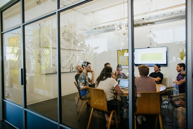 Staff discussion at a meeting room in office