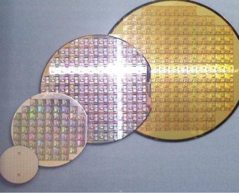 Silicon wafers with uncut integrated circuits (ICs). The diameter is 2, 4, 6, and 8 inches (from left to right).